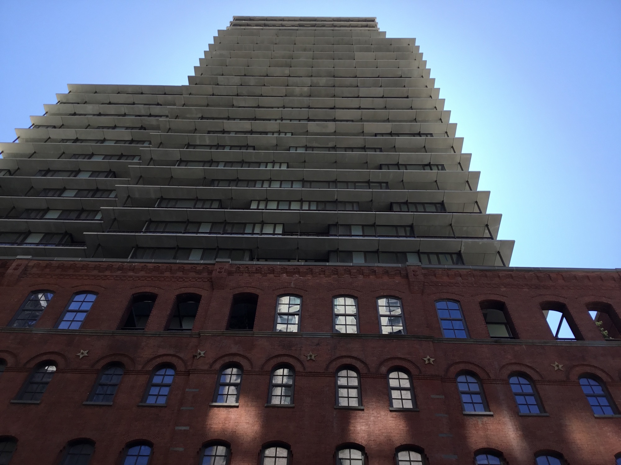 The new tower at 100 Vandam above its preserved brick exterior